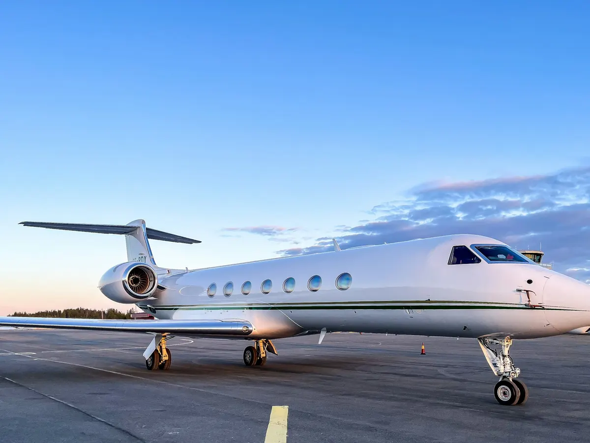 Large cabin Gulfstream jet parked on the ramp under a blue sky