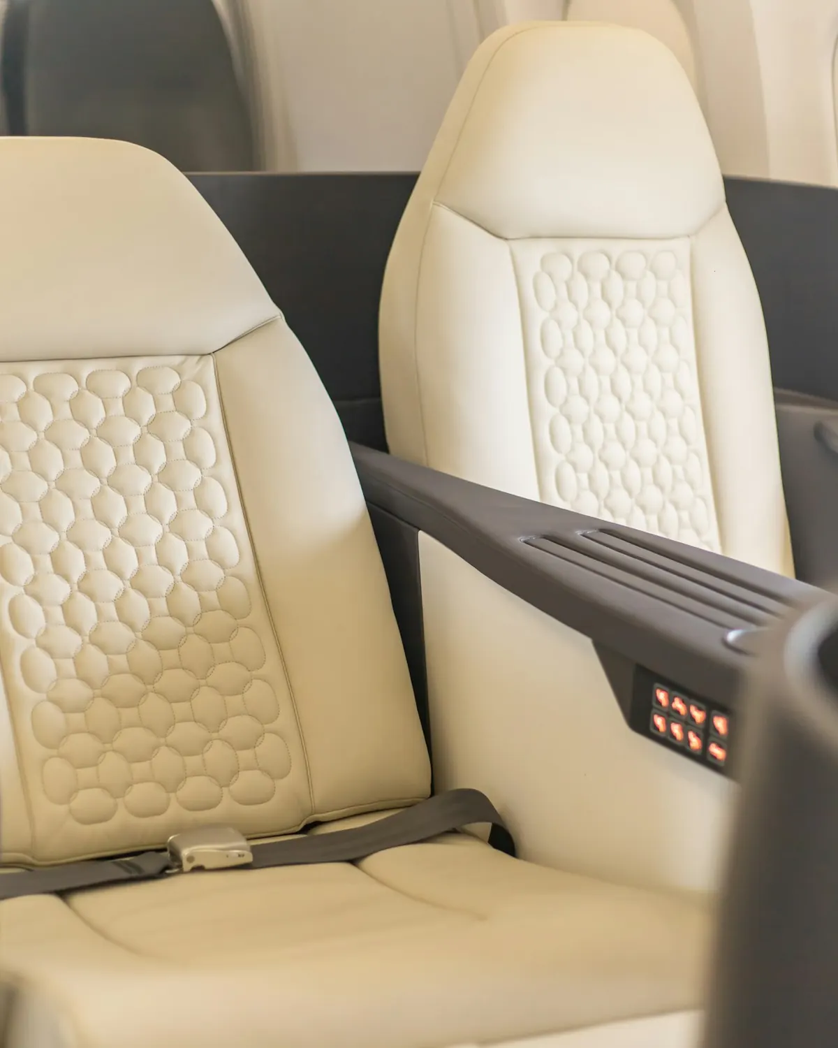 Cream quilted leather seat in a private jet cabin